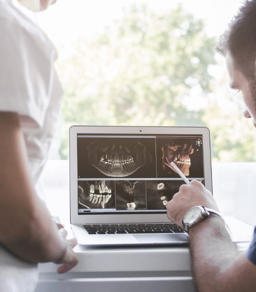 Dentist examining digital dental x-rays