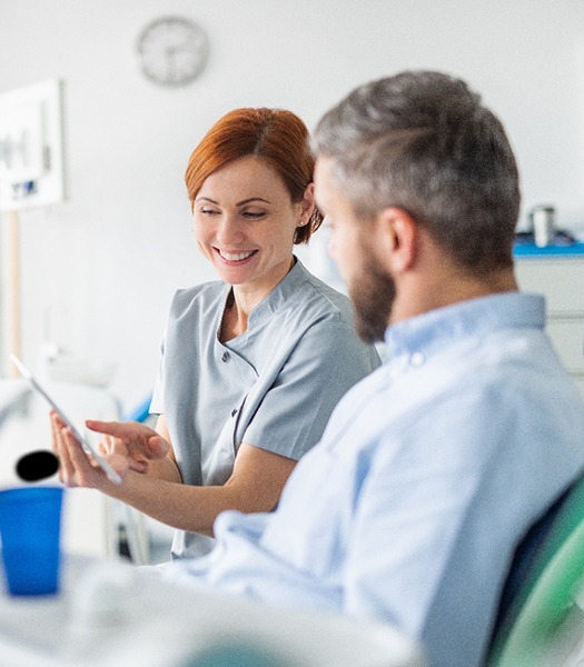 a dentist speaking with her patient