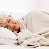 Woman sleeping peacefully with cozy blanket