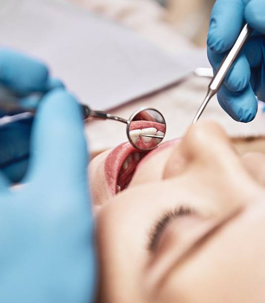 A close-up of dental tools being used for a dental checkup