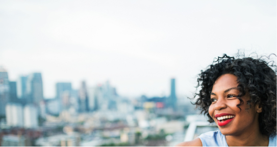 Smiling woman with city skyline in background