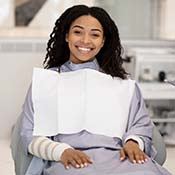 Woman smiling while visiting her implant dentist in Rancho Park