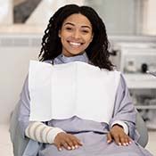 Woman smiling while visiting her implant dentist in Rancho Park