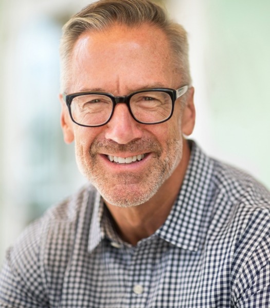 Man with dental implants smiling