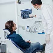 Implant dentist in Rancho Park showing patient a dental X-ray
