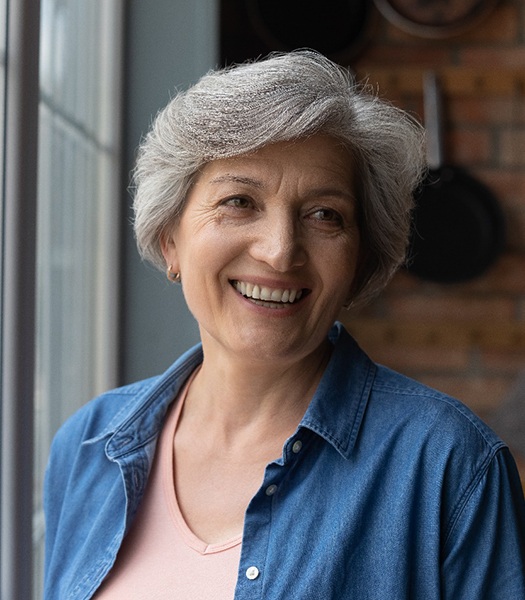 Woman holding dentures 