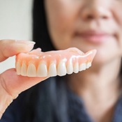 Dentures soaking in a glass