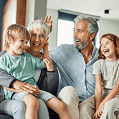 a mature couple enjoying time with their grandchildren