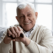 a mature man smiling with his new dentures