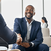 a man with dentures shaking someone’s hand