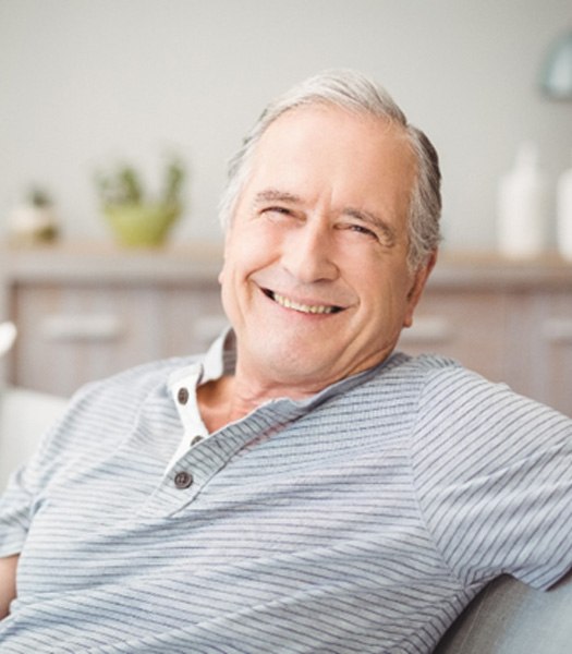 Senior man relaxing on a couch at home