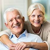 Older couple enjoying benefits of dental implants in Rancho Park