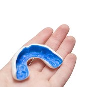Close-up of hand holding a mouthguard for bruxism