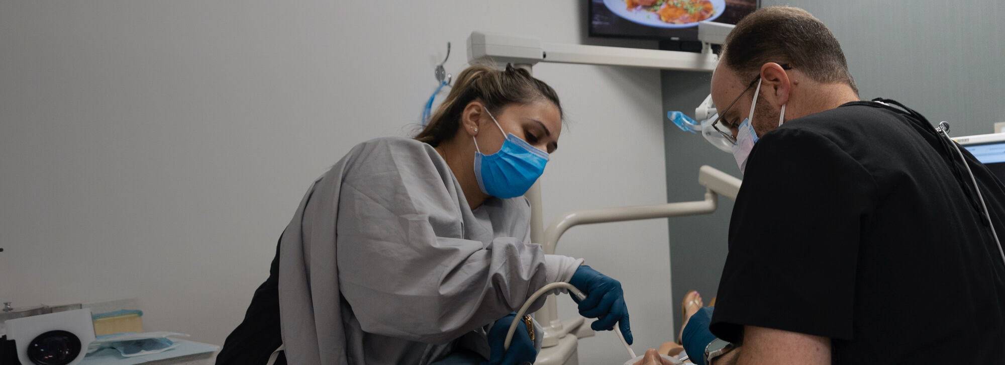 Los Angeles dentist and team member treating dental patient
