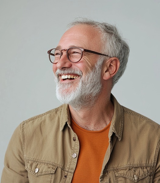 Man with black glasses smiling