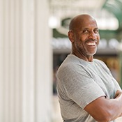Man with crossed arms smiling