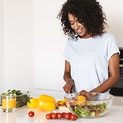 Woman preparing vegetables in kitchen