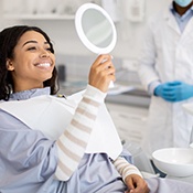 Woman smiling while looking at reflection