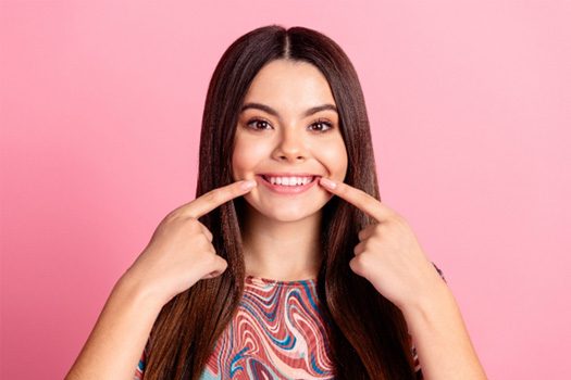 Woman pointing to her teeth