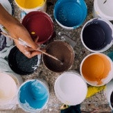 Open paint cans with a variety of different colors