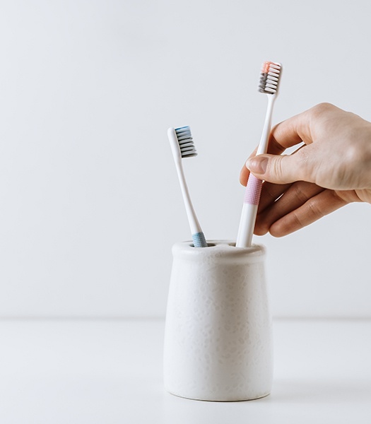 Taking toothbrush out of a toothbrush holder