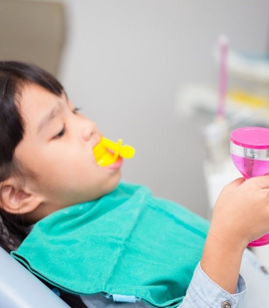 Child receiving fluoride treatment