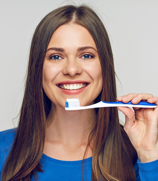 a woman in Los Angeles brushing her whitened teeth 