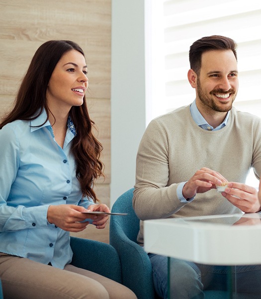 Couple discusses matters with dentist