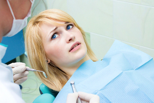 Woman afraid in the dental chair