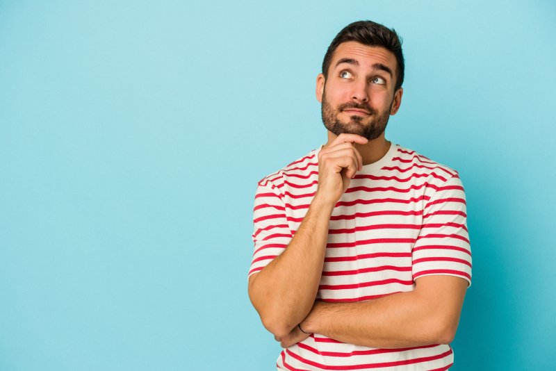 a man in a striped shirt thinking