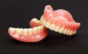 Upper and lower dentures stacked on top of each other