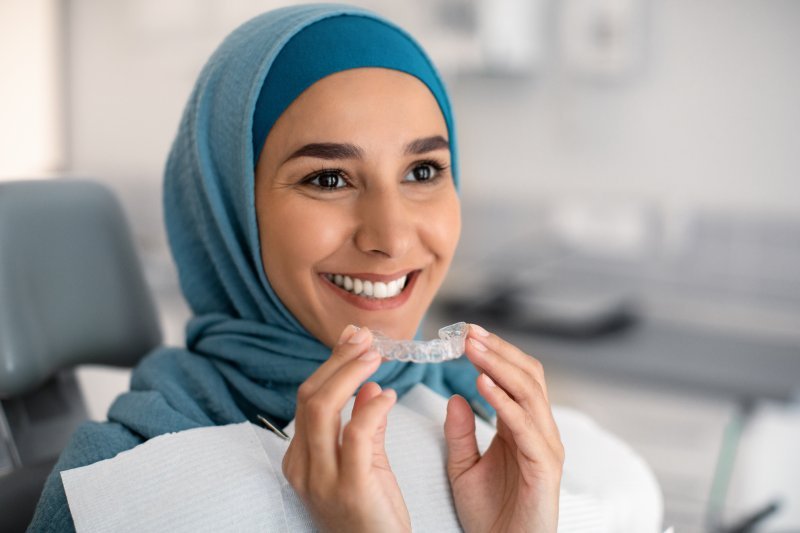 woman smiling with ClearCorrect aligner