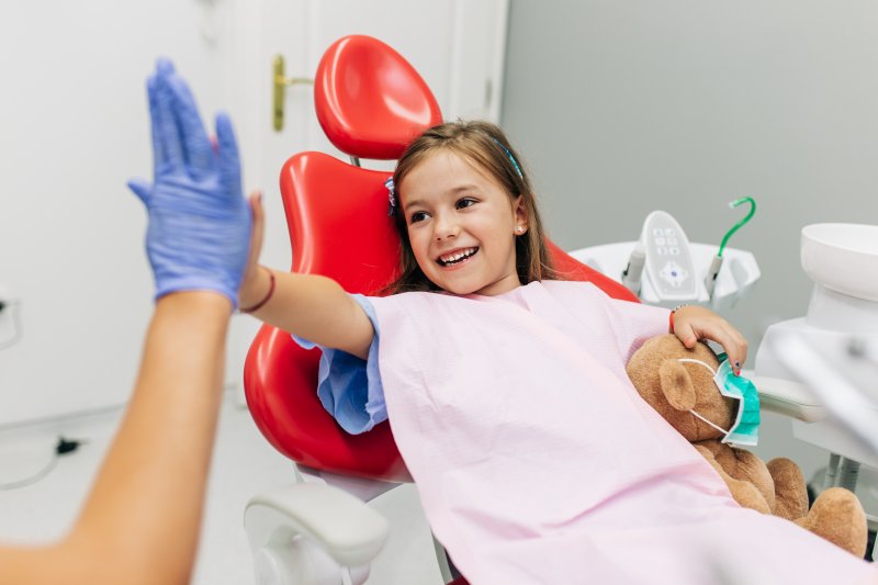 Little girl high-fives dentist