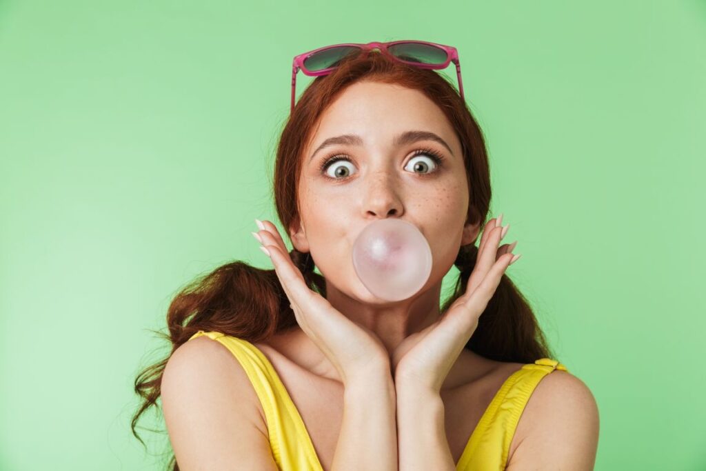 A girl blowing a gum bubble